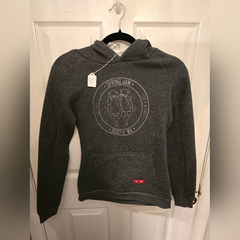 Gray Sweatshirt with Circular Emblem and Red Accent